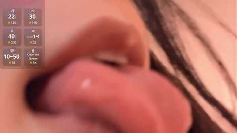 Media: A blurred video of a close-up of a person's mouth, possibly kissing. The image has a digital overlay showing statistics like \"22\" and \"10-50.\" The background is unclear, making it difficult to discern specific details.