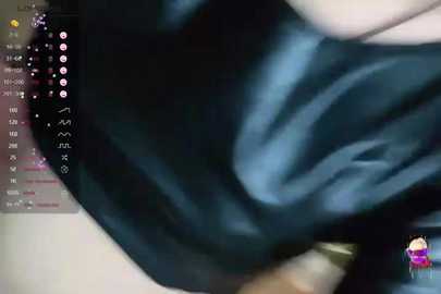 Media: A video shows a person's blurred, dark blue shirt, with a partially visible face and arm, captured in a dimly lit room.