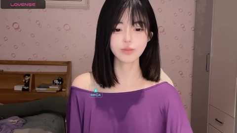 Media: A young, pale-skinned Asian woman with straight black hair, wearing a purple off-shoulder top, sits in a pink-patterned bedroom with a wooden bed and bookshelf in the background.