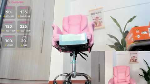 Media: Video of a pink, ergonomic office chair with a blue cushion, placed on a metal stand in a modern, minimalist office setting with a large potted plant and a wall calendar.