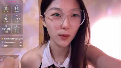 Media: A video of a young Asian woman with long black hair and glasses, wearing a white blouse. She's indoors with a blurred background, overlaid with a digital clock displaying 22:30.