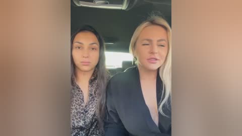 Media: Video of two women in a car; the woman on the left with long dark hair and leopard print top, the woman on the right with blonde hair and black blazer.