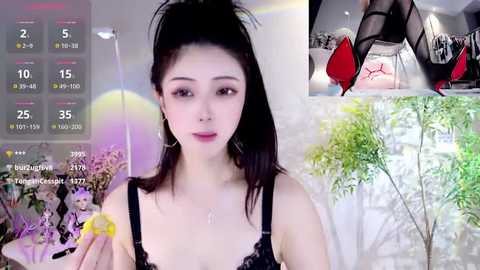 Media: Video of a young Asian woman with fair skin, wearing black lace lingerie, posing in a modern room with green plants. Overlay shows livestream metrics and an inset of her holding a camera.