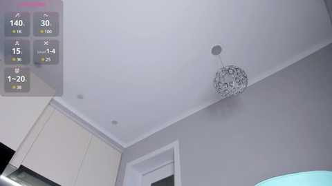 Media: Video of a modern room with a sleek, white ceiling and a silver, intricate chandelier hanging from the center. A digital overlay displays various room temperature readings and time.