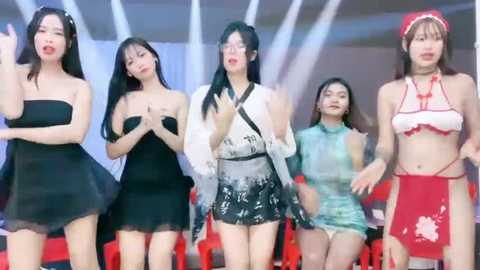 Media: Video of five Asian women in various revealing outfits, black and white dresses, red bikini, and a maid costume, dancing on stage.