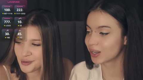 Media: A video of two women, one with long dark hair and glasses, the other with straight black hair, both smiling, set against a dark background.