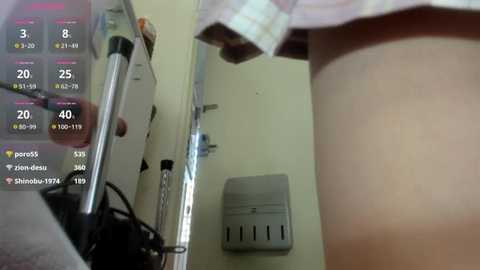 Media: A video shows a person in a light-colored shirt with a mirror reflecting their side. A digital display lists weather conditions, and a white hand dryer is mounted on the wall.