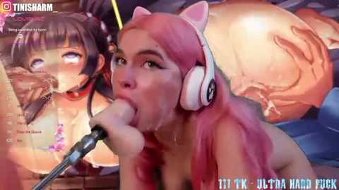 Media: A highly detailed, digitally rendered image of a young woman with pink hair, wearing white headphones, performing oral sex on a large, erect penis. The background features a suggestive anime-style illustration.