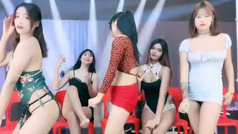 Media: Video of five Asian women in provocative attire, including red lace lingerie and black lace lingerie, standing against a backdrop of red chairs and white curtains.