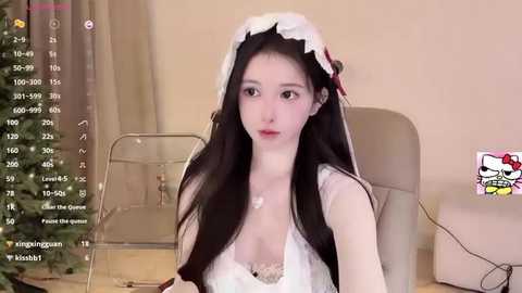 Media: A video of a young East Asian woman with long black hair in a maid costume, sitting in a beige chair, with a livestream overlay on the left.