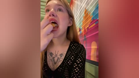 Media: A video of a fair-skinned, long-haired woman with a butterfly tattoo on her chest, licking a chocolate cone in a vibrant, colorful, indoor setting.