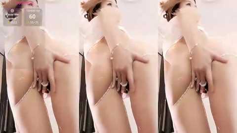 Media: A series of three videos shows a light-skinned woman with auburn hair, wearing a sheer, white, lace thong, exposing her vulva, in a mirrored room.