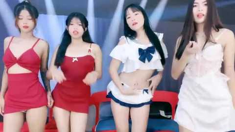 Media: Video of four Asian women in revealing outfits, red mini-dress, white crop top, white dress, and white ruffled skirt, posing with playful expressions against a blue and white backdrop.