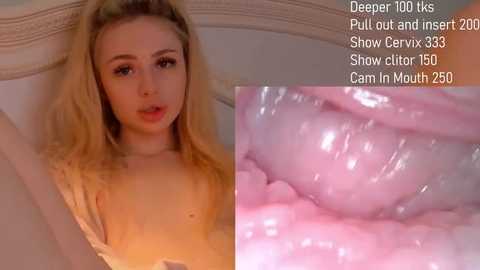 Media: Video of a blonde woman with fair skin, wearing a sheer top, lying on a bed. Text overlay shows she's performing a deepthroat act.