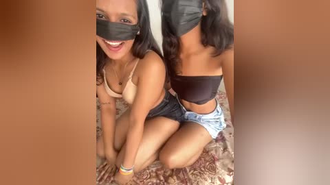 Media: Video of two smiling, masked women in casual attire on a patterned rug, with a brown border.