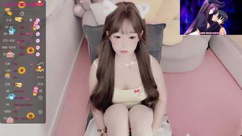 Media: A photo of a young Asian woman with long brown hair and a pale complexion, sitting on a pink carpet, wearing a white tank top, in a softly lit room.