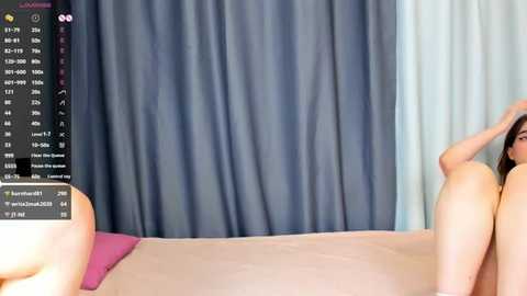 Media: A video shows a nude woman with fair skin, long dark hair, lying on a bed with light brown sheets. A dark blue curtain backdrop and a pink pillow are visible. The image includes a computer screen displaying a chat window.