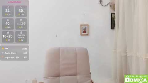 Media: A video of a modern bedroom with a white wall, a cream-colored chair, and a small framed picture; a digital display shows temperature and humidity readings.