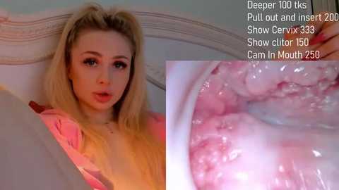 Media: Video of a young, blonde woman with a shocked expression, wearing a pink hoodie, in a dimly lit bedroom. Close-up of an open cervix with a pinkish hue and visible mucous.