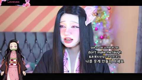 Media: A video shows a woman with long black hair and pink bow, crying. A smaller image of a girl in a pink kimono and black robe stands to her left. Text in Korean overlays the image.