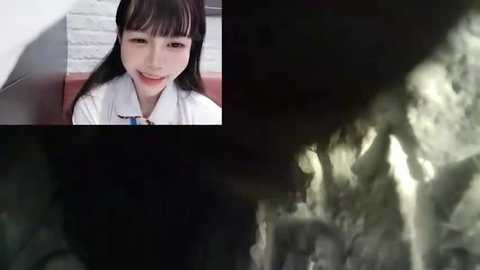 Media: Video of a smiling East Asian woman in a white shirt, next to a dark, shadowy tunnel with a white light source at the end.