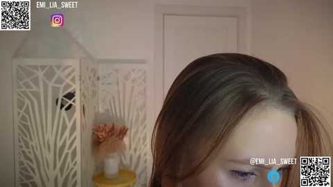 Media: A video shows a close-up of a woman's face with light skin, brown hair, and soft makeup, against a white background. QR codes and social media icons are visible in the top corners.