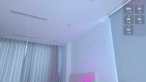 Video of a modern, white room with a minimalist design featuring a large white wall and a partially visible white curtain. The ceiling has recessed lighting. A digital display on the right shows 360-degree video controls.