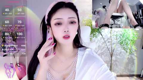 Media: A video of an Asian woman with long black hair, wearing a white robe, sitting in a modern, bright room with plants. Overlay shows an augmented reality video call.