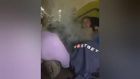 Media: A video captures a woman with dark hair, wearing a blue hoodie, sitting in a car with a white, possibly furry, creature visible through the fogged-up window.