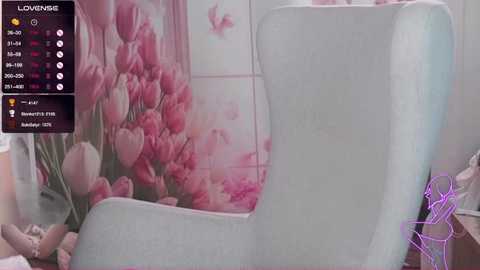 Media: Video of a pastel blue bathtub with a floral wall mural, featuring pink tulips and butterflies. A purple towel is draped over the tub handle.