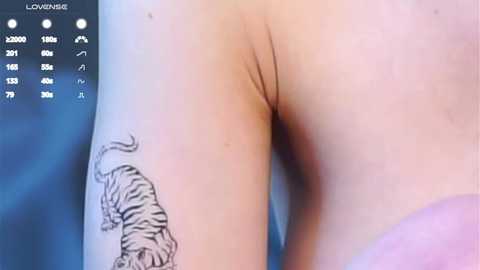 Media: Video of a nude person with pale skin, showing a detailed black tiger tattoo on the left thigh. The background is a blurred blue and purple gradient.