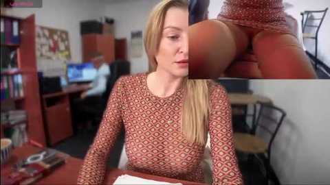 Media: Video of a blonde woman in a patterned dress, holding a large, realistic dildo, in a cluttered office with bookshelves and computer screens.