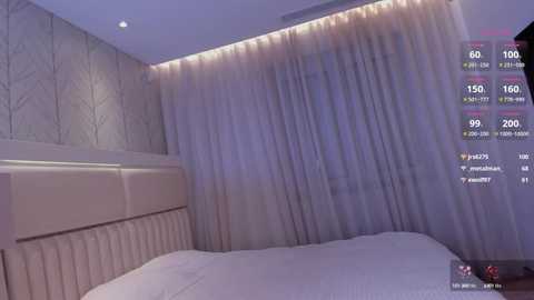 Media: Video of a modern bedroom with a beige padded headboard, white bedding, and floor-to-ceiling sheer curtains. A digital overlay displays a virtual temperature of 60 degrees and humidity of 50%.