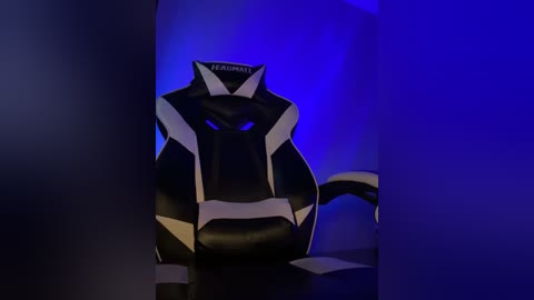 Media: Video of a sleek, black, angular, robot-like sculpture against a blue background, with an abstract, futuristic design and a prominent \"XAGAMAT\" logo on its head.