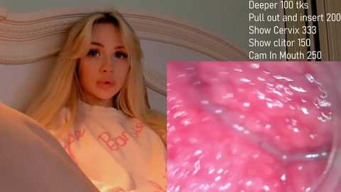 Video of a blonde woman lying on a bed, wearing a pink nightgown, with text overlay showing Deepthroat 100, Pull Out and Insert, Show Cervix 35, Show Clitoral 150, and Cam in Mouth 250.