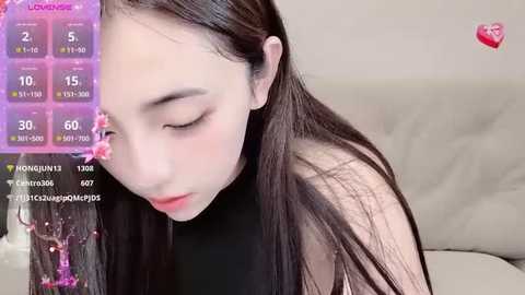 Media: Video of a young Asian woman with long black hair, wearing a black top, eyes closed, and looking serene, with a live stream overlay displaying stats.