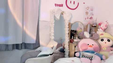 Media: Video of a cozy, girly bedroom with a mirror, plush toys, and a smiling face on the wall; pastel colors, white drapes, and a soft, inviting atmosphere.