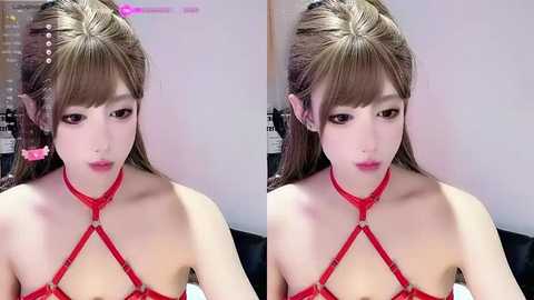 Media: Video of a young East Asian woman with light skin, straight brown hair, and bangs. She wears a red strappy harness top, appearing solemn in a minimalist room with a blurred background.