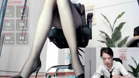 Media: Video of a woman in black sheer stockings and high heels sitting in an office chair, with a calendar displaying \"Loving\" and \"Loving You\" on the wall.