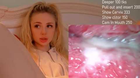 A video of a blonde woman with fair skin, wearing a light-colored top, lying on a bed, with a close-up of a pink, wet cervix in the background.