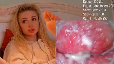 A video of a young blonde woman with fair skin, wearing a beige jacket, sitting on a bed. Text overlay: \"Deepthroat 100+ks Pull out and insert Show cervix 35% Show clit 150% Cam in mouth 25%\