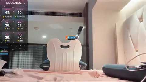 Media: Video of a modern hotel room with a white guitar on a bed, a television screen displaying a live broadcast of a basketball game, and a partially visible black and white checkered patterned window.