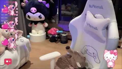 Video of a room featuring a white gaming chair with Hello Kitty and My Melody plush toys, pink heart decorations, and a Hello Kitty cushion.