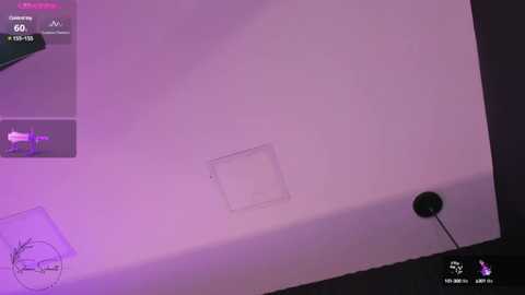 Media: Video of a modern, minimalist room with a white wall, a rectangular light fixture, and a small circular speaker on the floor. The scene is bathed in soft purple lighting.