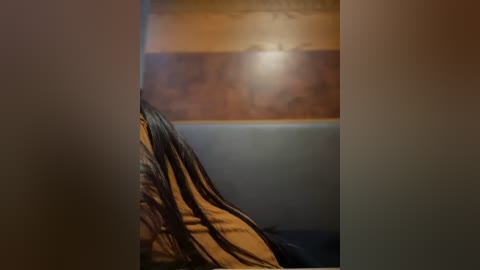 Media: Video of a dimly lit, cozy bedroom with a wooden headboard, a beige blanket, and a muted blue wall. The lighting casts a warm glow, creating a serene atmosphere.