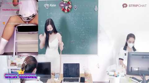 Media: A video featuring an Asian woman in a white dress, seated at a desk with a laptop, surrounded by office supplies and a chalkboard.