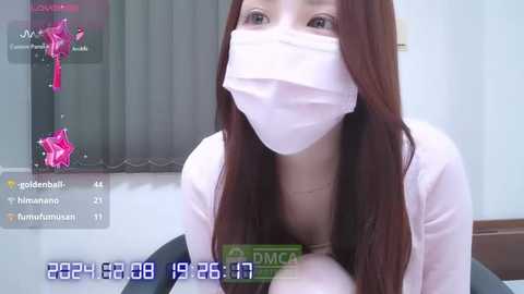 Media: A video captures a woman with long brown hair and a white mask, sitting indoors. The image is overlaid with a video call screen showing a pink star and the time stamp 2024-06-26 11:57:17.