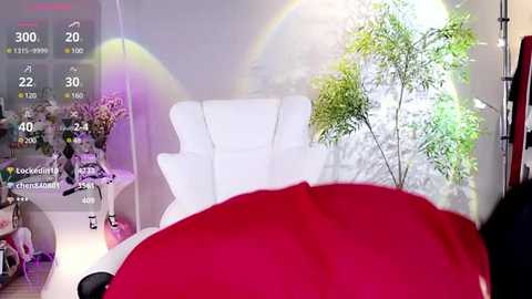 Media: Video of a modern bedroom with a white chair, red bedspread, green potted plant, and colorful digital overlays of a rainbow and temperature gauge, reflecting a playful, technologically enhanced aesthetic.