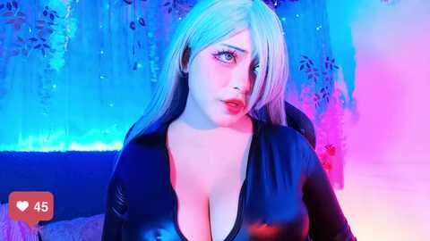 Media: Video of a pale-skinned woman with long platinum blonde hair, wearing a tight, shiny black latex dress, in a room with blue and pink neon lighting, and silver tassel curtains.