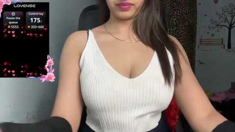 Media: A video of a woman with medium skin tone, wearing a white ribbed tank top, sitting indoors, with a \"LoveNGK\" overlay displaying 175 viewers and 3.5-4.5 hours.